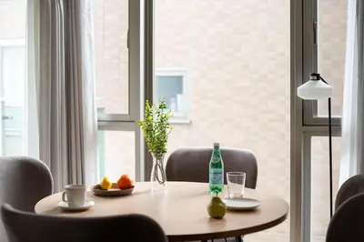 a table with a vase and a bottle on it at \u30e9\u30b9\u30d1\u30b7\u30aa\u9ebb\u5e03\u7b04\u753a\u30ec\u30b8\u30c7\u30f3\u30b9 in Tokyo
