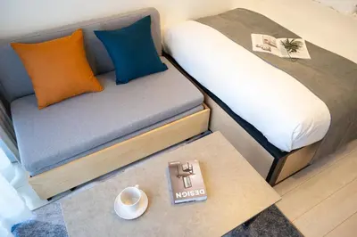 a small room with a bed and a table at Noble Park RYOGOKU in Tokyo