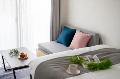 a bedroom with a bed and a couch and a table at Noble Park RYOGOKU in Tokyo