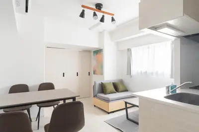 a kitchen and living room with a table and chairs at Noble Park RYOGOKU in Tokyo