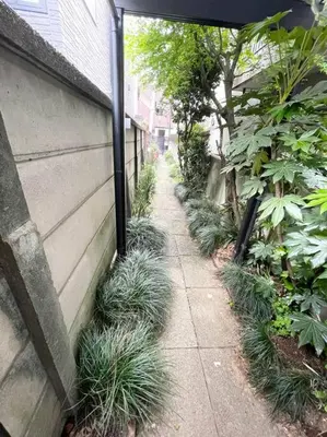 a sidewalk with plants next to a building at Walk to World Athletics! Prime Omotesando 2min sta in Tokyo
