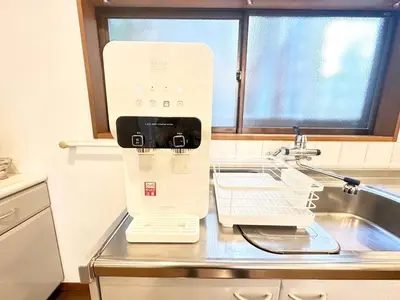 a kitchen counter with a white appliance on a sink at Walk to World Athletics! Prime Omotesando 2min sta in Tokyo