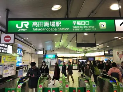 a group of people walking through an airport with luggage at \u30b0\u30ea\u30fc\u30f3\u30cf\u30a6\u30b9 in Tokyo