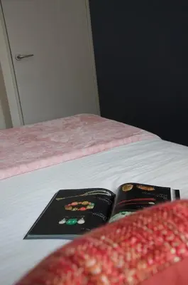 two books sitting on top of a bed at \u5168\u65b0\u88c5\u4fee\u5357\u54c1\u5dddhaven\u6625 in Tokyo