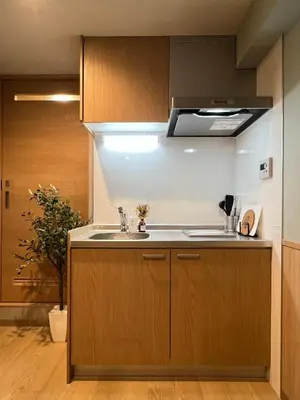 a kitchen with a sink and a stove at nestay inn tokyo tsukiji in Tokyo