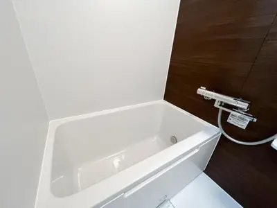 a white bath tub sitting in a bathroom at Ikebukuro Area 1F03 NishiikeApartment in Tokyo
