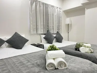 a hotel room with two beds with towels on them at Ikebukuro Area 1F03 NishiikeApartment in Tokyo