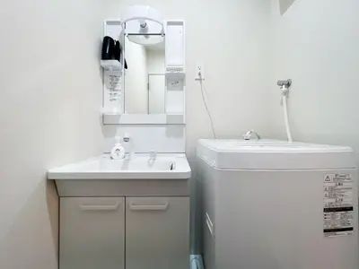 a small bathroom with a sink and a mirror at Ikebukuro Area 1F03 NishiikeApartment in Tokyo
