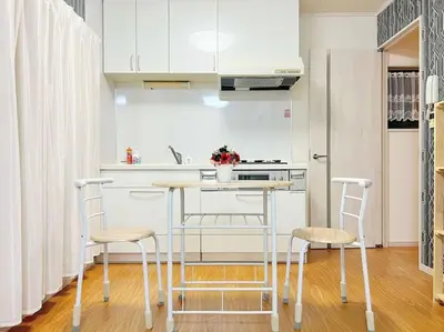 a kitchen with a counter and stools in a kitchen at Easily to Ikebukuro Asakusa Shibuya for 5 in Tokyo