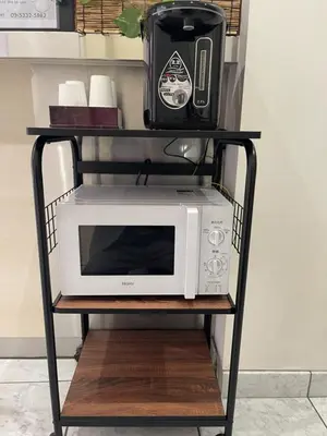 a microwave on a black stand with a toaster oven at Hotel Grand Fort - Vacation STAY 85486v in Tokyo