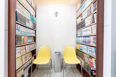 two chairs in a library with dvds at Hotel Grand Fort - Vacation STAY 85455v in Tokyo