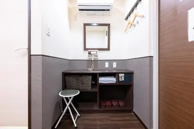 a bathroom with a vanity with a mirror and a stool at Hotel Grand Fort - Vacation STAY 85455v in Tokyo
