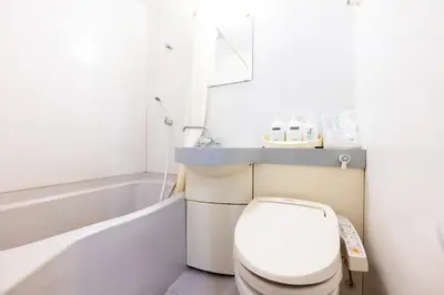a bathroom with a toilet and a bath tub at Hotel Grand Fort - Vacation STAY 85406v in Tokyo