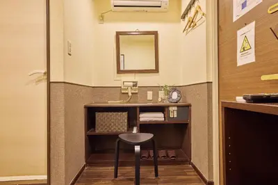 a bathroom with a vanity with a stool and a mirror at Hotel Grand Fort - Vacation STAY 85406v in Tokyo