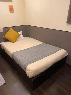 a bedroom with a bed with a yellow pillow at Hotel Grand Fort - Vacation STAY 85501v in Tokyo