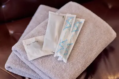 a towel with two pieces of paper on it at Hotel Grand Fort - Vacation STAY 85443v in Tokyo