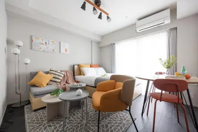 a living room with a couch and a table at PREAs\u4e2d\u91ce\u65b0\u4e95 in Tokyo