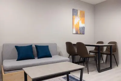 a living room with a couch and a table at PREAs\u4e2d\u91ce\u65b0\u4e95 in Tokyo