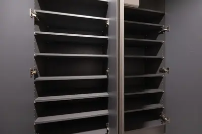 a walk in closet with black shelves at PREAs\u4e2d\u91ce\u65b0\u4e95 in Tokyo