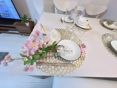 a table with a tray with a plate and flowers at Spacious Cozy house in Shinjuku Free parking wifi in Tokyo