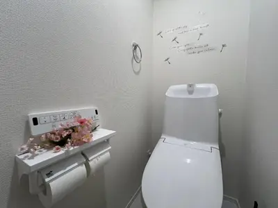 a bathroom with a toilet with a clock on the wall at Spacious Cozy house in Shinjuku Free parking wifi in Tokyo