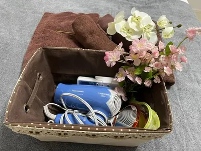 a suitcase with flowers and other items in it at Spacious Cozy house in Shinjuku Free parking wifi in Tokyo