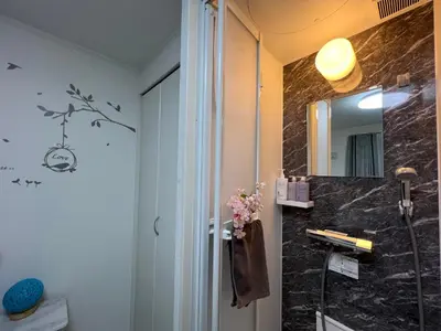 a bathroom with a shower and a black marble counter at Spacious Cozy house in Shinjuku Free parking wifi in Tokyo