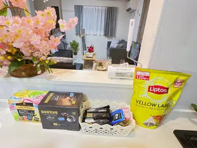 a counter with a table with some snacks and flowers at Spacious Cozy house in Shinjuku Free parking wifi in Tokyo