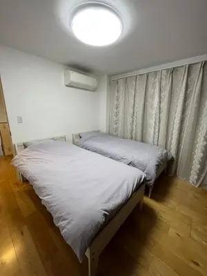 two beds in a bedroom with a light on the ceiling at \u9759\u8c27\u65f6\u5149 in Tokyo