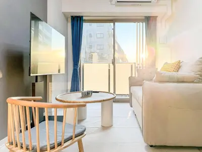 a living room with a couch and a table at Triphome Tokyo Sugamo 2024 New 3 mins 2 stations in Tokyo