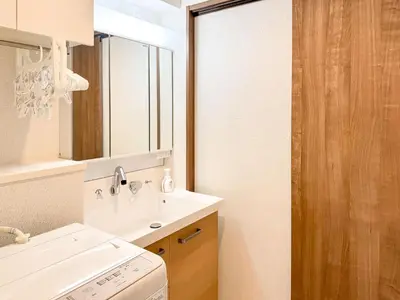 a bathroom with a sink and a washing machine at Triphome Tokyo Sugamo 2024 New 3 mins 2 stations in Tokyo