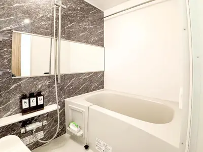 a bathroom with a white tub and a shower at Triphome Tokyo Sugamo 2024 New 3 mins 2 stations in Tokyo
