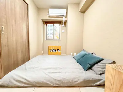 a bedroom with a large bed in a room at Triphome Tokyo Sugamo 2024 New 3 mins 2 stations in Tokyo