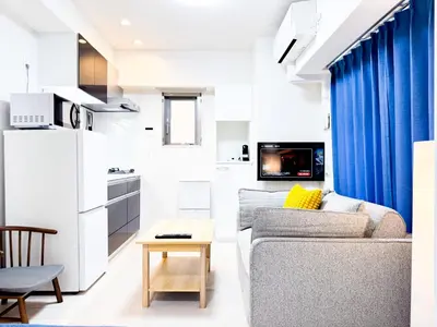 a living room with a couch and a table at Triphome Tokyo Sugamo 2024 New 3 mins 2 stations in Tokyo