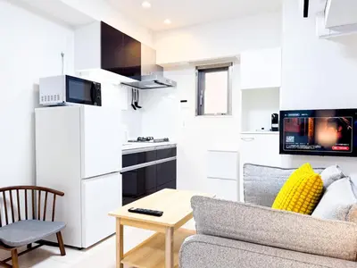 a living room with a couch and a table at Triphome Tokyo Sugamo 2024 New 3 mins 2 stations in Tokyo