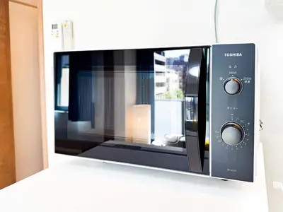 a microwave oven sitting on a wall at Triphome Tokyo Sugamo 2024 New 3 mins 2 stations in Tokyo