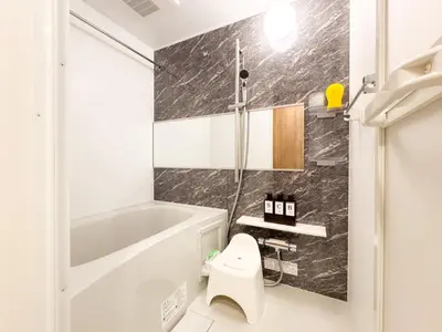 a bathroom with a white tub and a toilet at Triphome Tokyo Sugamo 2024 New 3 mins 2 stations in Tokyo