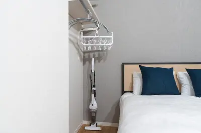 a bedroom with a bed with a light next to it at Jeunesse\u7acb\u82b1 in Tokyo