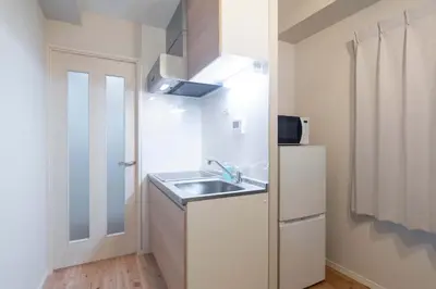 a small kitchen with a sink and a refrigerator at Jeunesse\u7acb\u82b1 in Tokyo