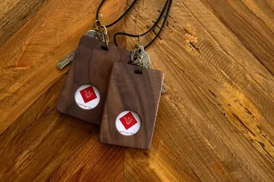 two bags on a necklace on a wooden floor at Origami-ya Stay Zen - Luxury Asakusa Penthouse in Tokyo