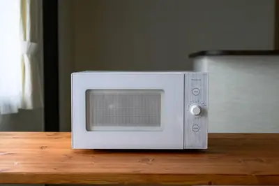 a microwave sitting on top of a wooden table at Origami-ya Stay Zen - Luxury Asakusa Penthouse in Tokyo