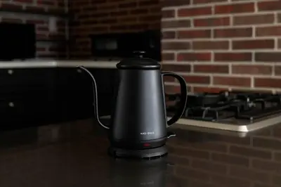a black kettle sitting on a counter next to a stove at Origami-ya Stay Akari - Luxury Asakusa Penthouse in Tokyo