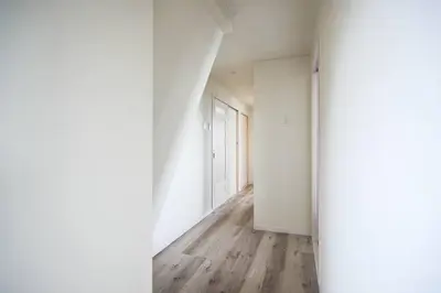 an empty hallway with white walls and wooden floors at Origami-ya Stay Akari - Luxury Asakusa Penthouse in Tokyo