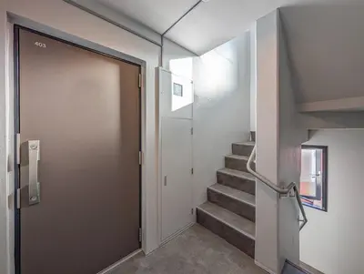 a door leading into a hallway with stairs at japan house Ikebukuro 2 in Tokyo
