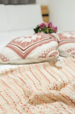 two pink and white pillows on a bed at japan house Ikebukuro 2 in Tokyo