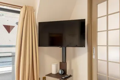 a flat screen tv hanging on a wall at \u8aa0\u5fc3\u58024f in Tokyo
