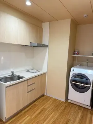 a kitchen with a sink and a washing machine at Etsu in Tokyo