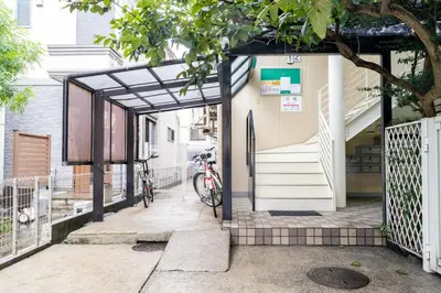 a bike parked outside a building with a gate at Home Story in Tokyo \u6c5f\u6238\u5ddd\u533a\u5e73\u4e95\u99c5-\u4e0a\u91ce \u79cb\u8449\u539f\u307e\u3067\u76f4\u901a in Tokyo
