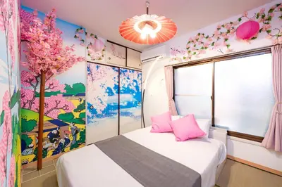 a bedroom with a bed with pink pillows and a tree mural at A 3rooms MAX8people 6min Shinjuku 11min Shibuya 12min walk Ikebukuro LEON RESORT IKEBUKURO traditional Japanese room \u6c60\u888b \u6700\u59278\u540d in Tokyo