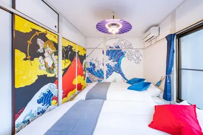 a bedroom with a white bed and a mural at A 3rooms MAX8people 6min Shinjuku 11min Shibuya 12min walk Ikebukuro LEON RESORT IKEBUKURO traditional Japanese room \u6c60\u888b \u6700\u59278\u540d in Tokyo